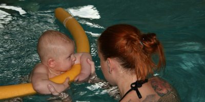 Žena s malým dítětem v bazéně