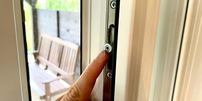 Prst ukazuje na šroub na okně