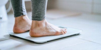 Žena stojí na osobní váze