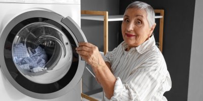 Starší žena u pračky