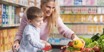 Matka s malým synem nakupuje zeleninu v supermarketu