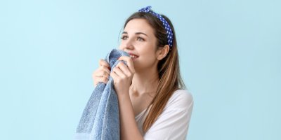 Žena čuchá k ručníku