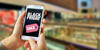 Ruce držící mobilní telefon s logem Black Friday