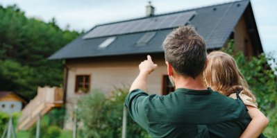 Muž ukazuje na střechu s fotovoltaikou