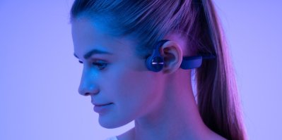 Žena má na uších bezdrátová sluchátka