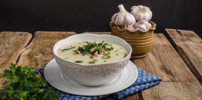 Kedlubnová polévka v bílé misce, položená na talíři