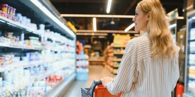 Žena vybírá v supermarketu mléčné výrobky