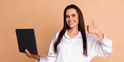 Žena se usmívá a drží notebook