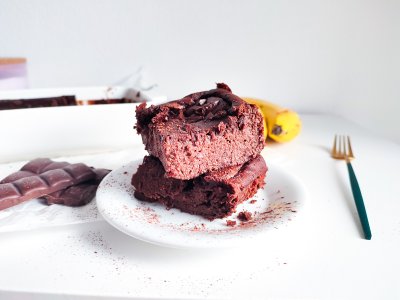 Fazolové brownies na talířku, vedle zapékací forma s brownies v pekáčku, banány a čokoláda