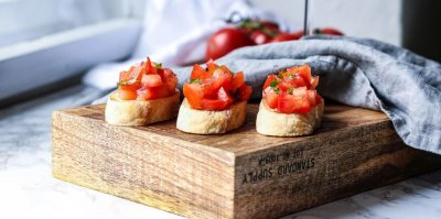 Italská bruschetta servírovaná na dřevěném prkénku